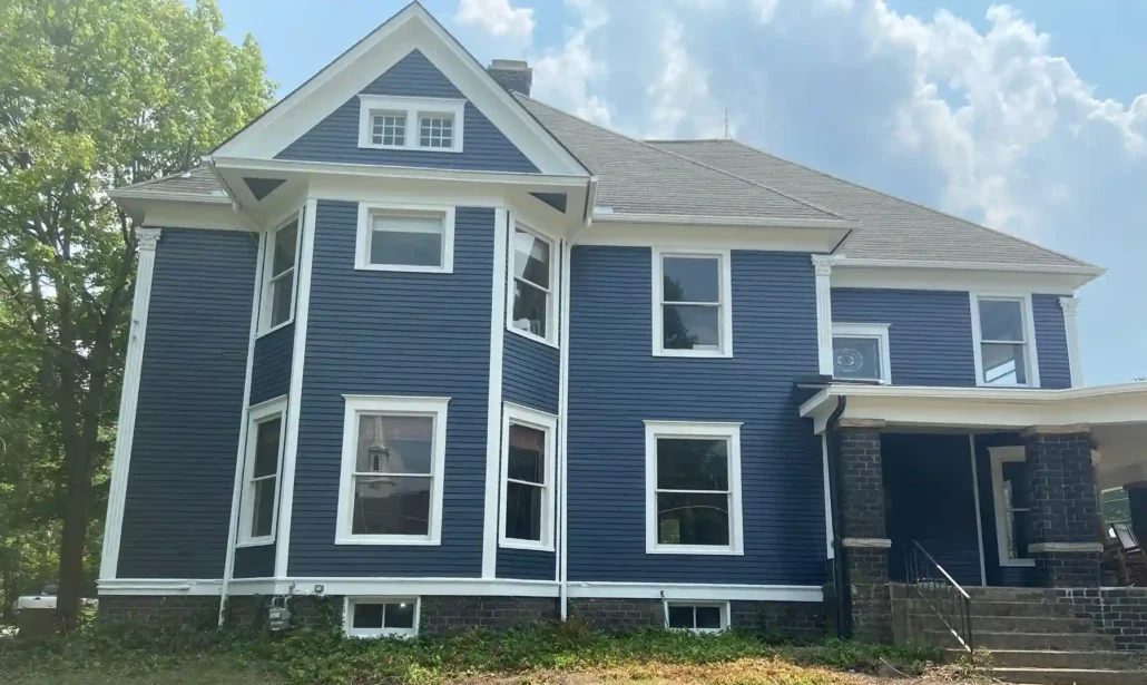 A Two Story Home in Columbiana with Deep Blue Siding and Bright White Accents.