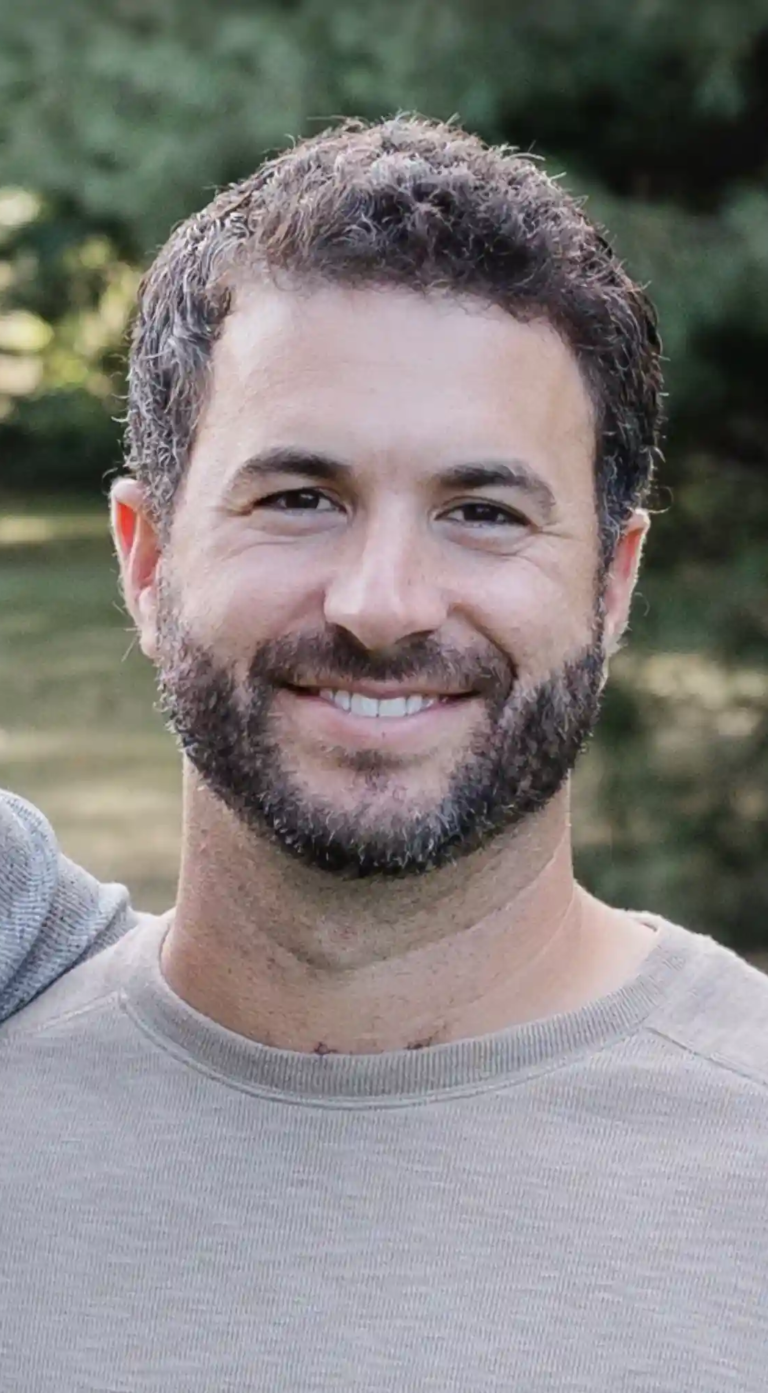 Headshot of Dom Daltorio, Co-Owner of P & D Painting with a Green, Vibrant Background.