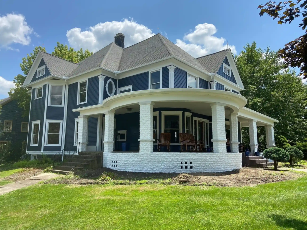 Freshly Painted Blue Siding Shines Bright in the Sun.