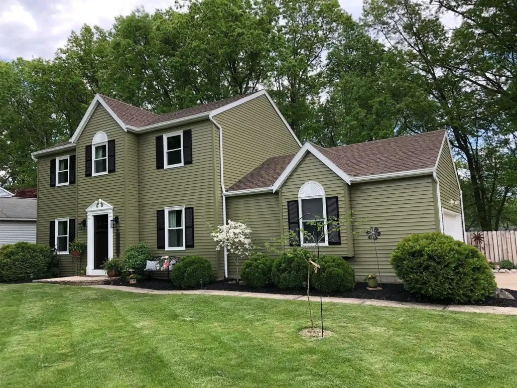 An Olive Green Painted Siding is Complemented Nicely by Fresh, White Painted Trim.