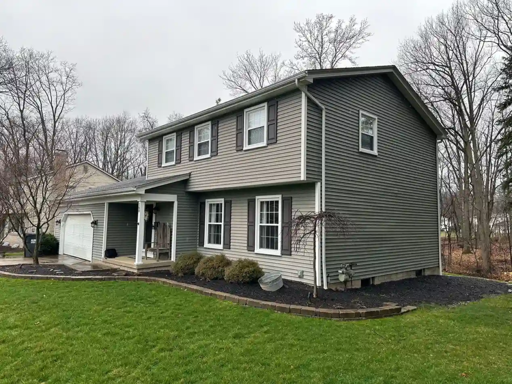 Gray, Freshly Painted Two Story Home Near Warren with White Trim and Black Shutters.
