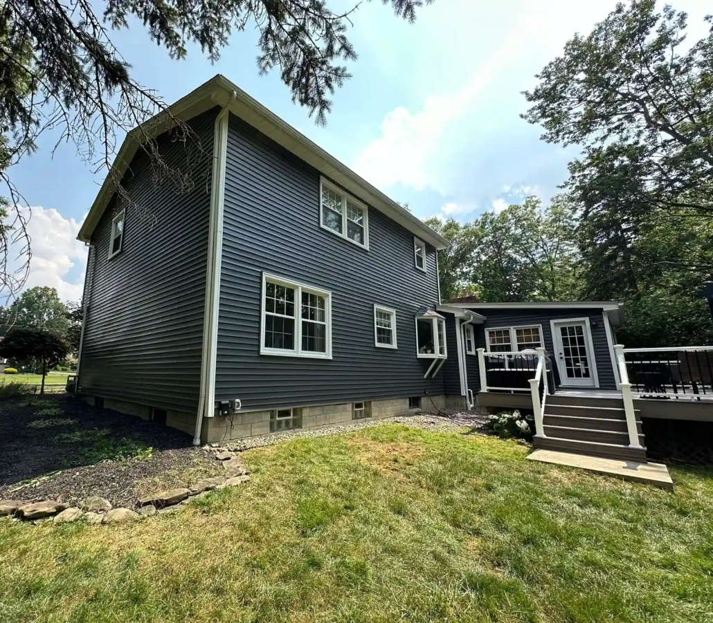 A Freshly Painted Home Near Youngstown with Charcoal Gray Siding and White Trim Shines Bright in the Sun.