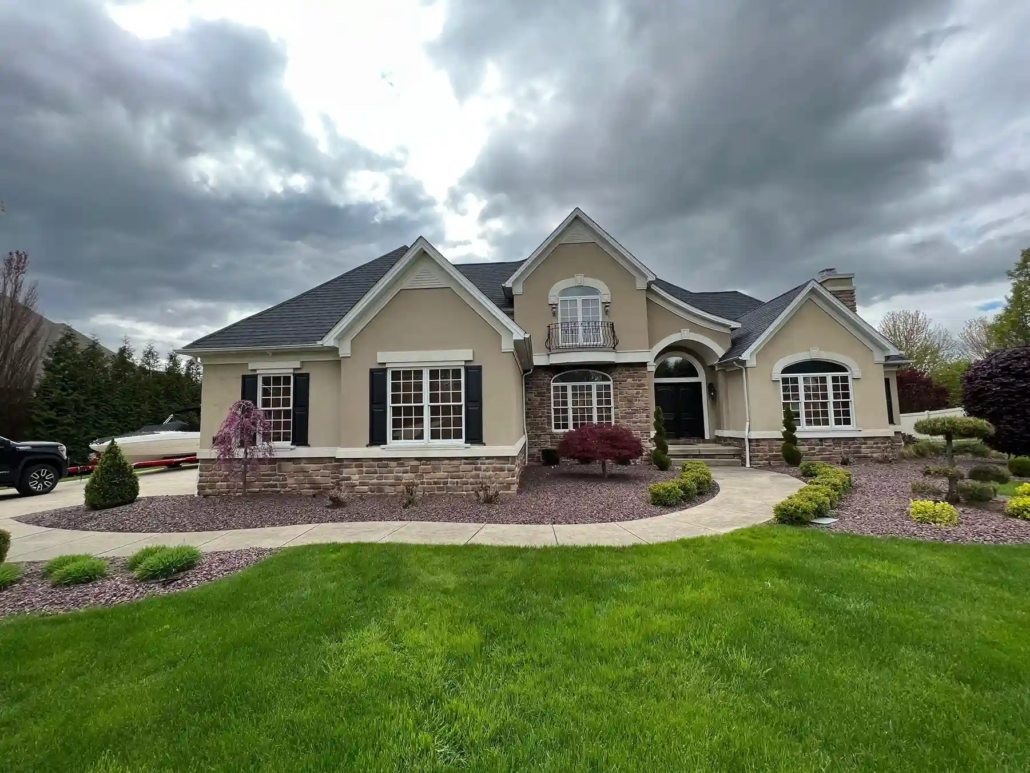 Warren Residential Exterior Painted Beige with White Trim and Black Shutters.