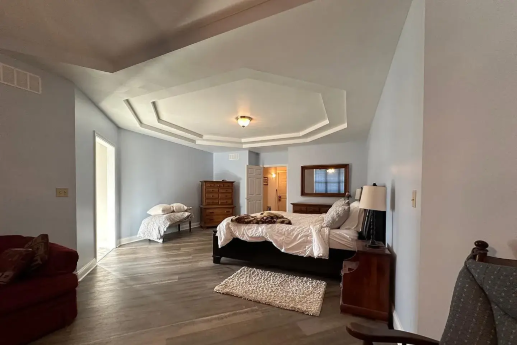 An Open-Concept Master Bedroom in Canfield with Lots of Natural Light Bouncing off of the Freshly Painted Light Blue Walls.