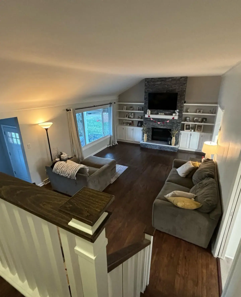 A Bright, Modern Living Room with Warm Ambient Lighting Reflecting Off Freshly Painted Light Gray Walls and the Charcoal Stone TV Stand Accent Piece.